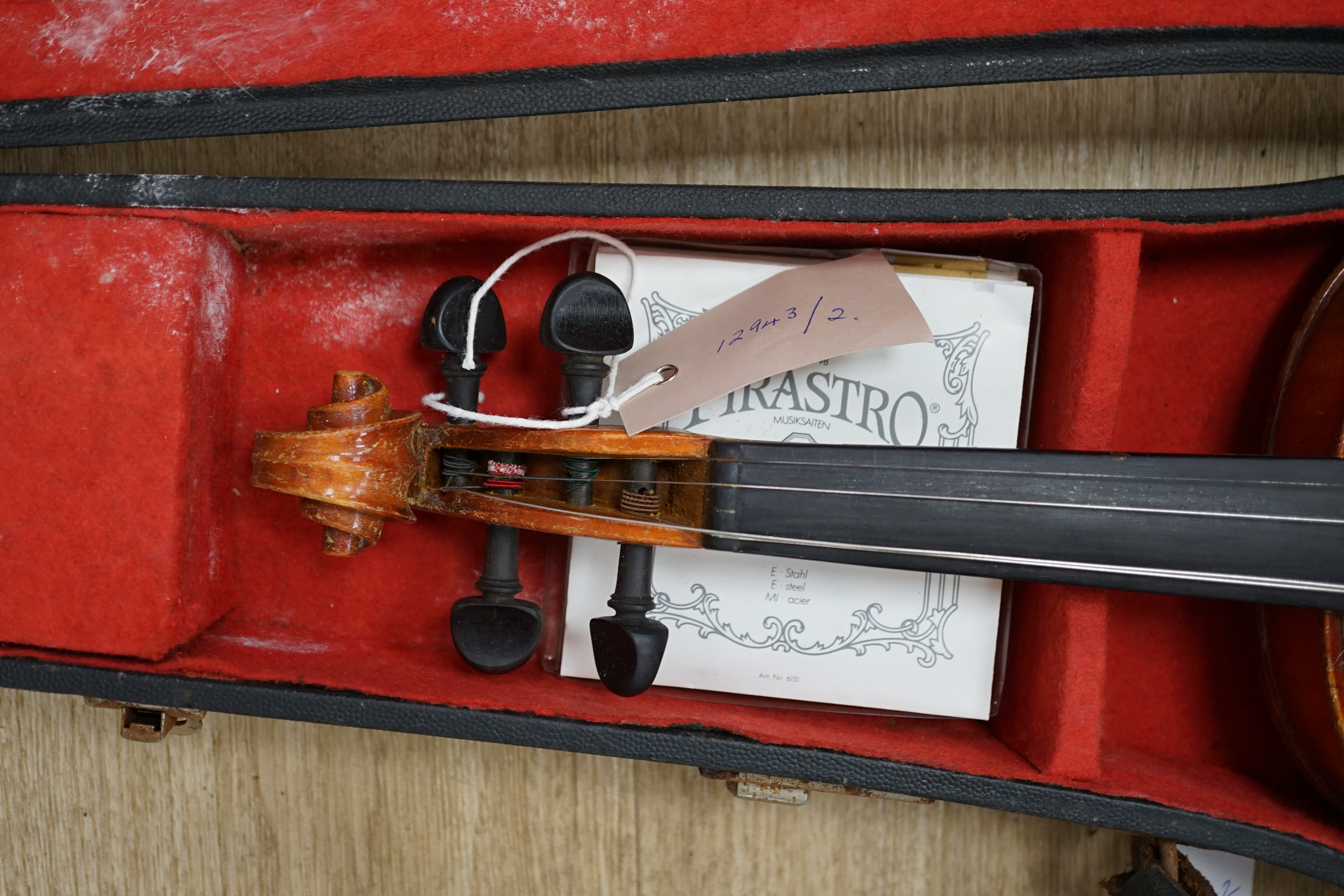 A cased Czechoslovakian student’s violin with Stradivarius label, length of body, 35.5cm, with spare strings